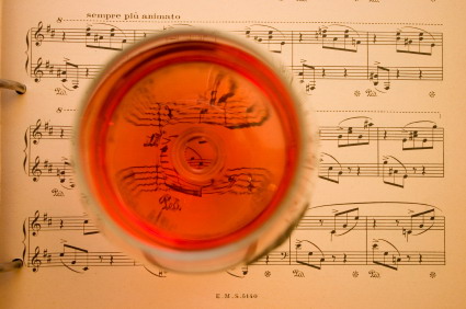 Old sheet music with goblet of wine shot from above.